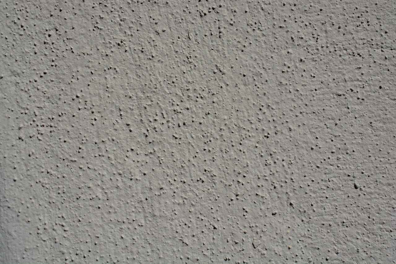 A close-up view showcasing the intricate texture of a gray stucco wall, perfect for backgrounds.